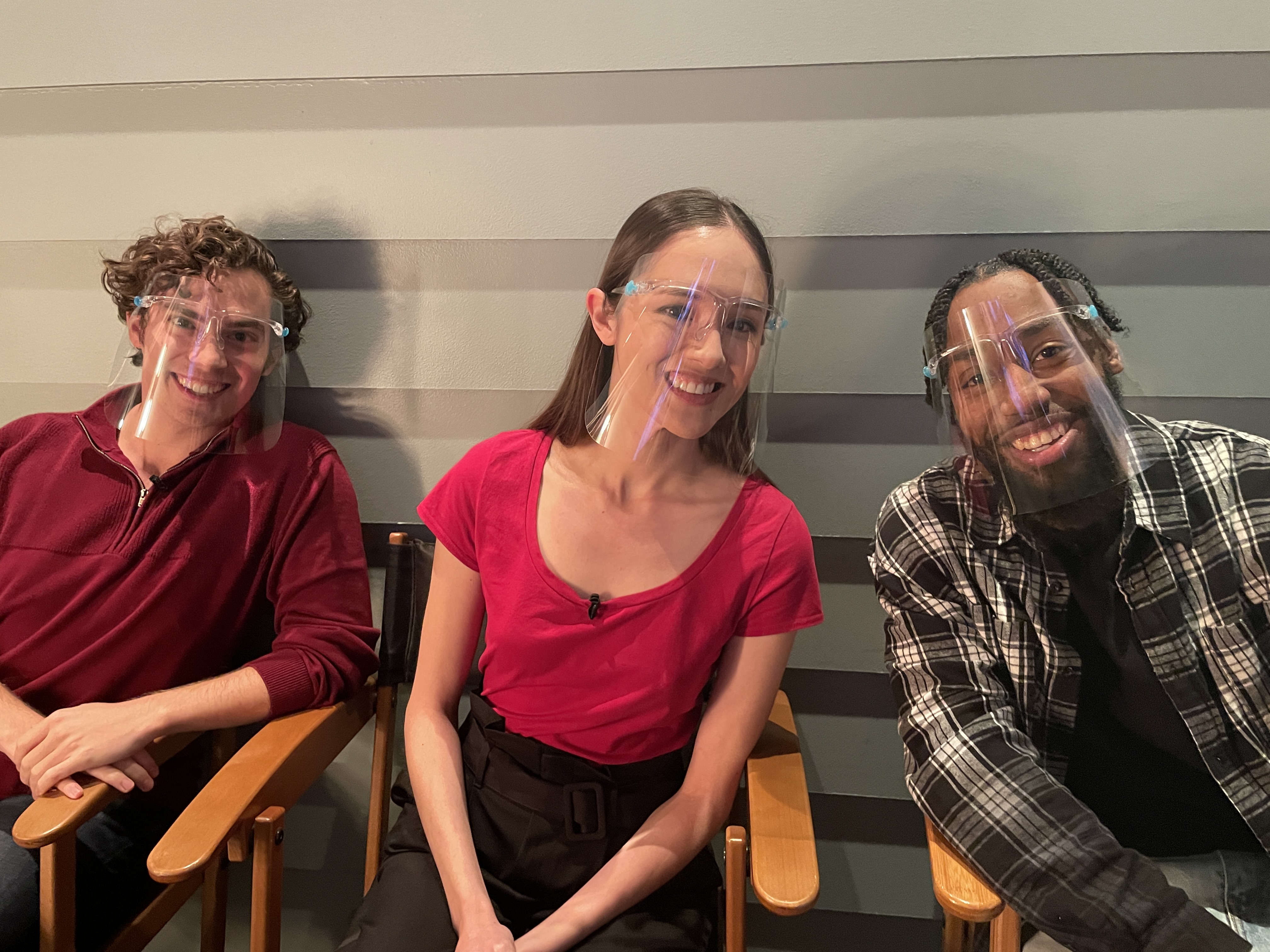 Neil and two others in face shields, laughing in director's chairs on the Ellen Show set